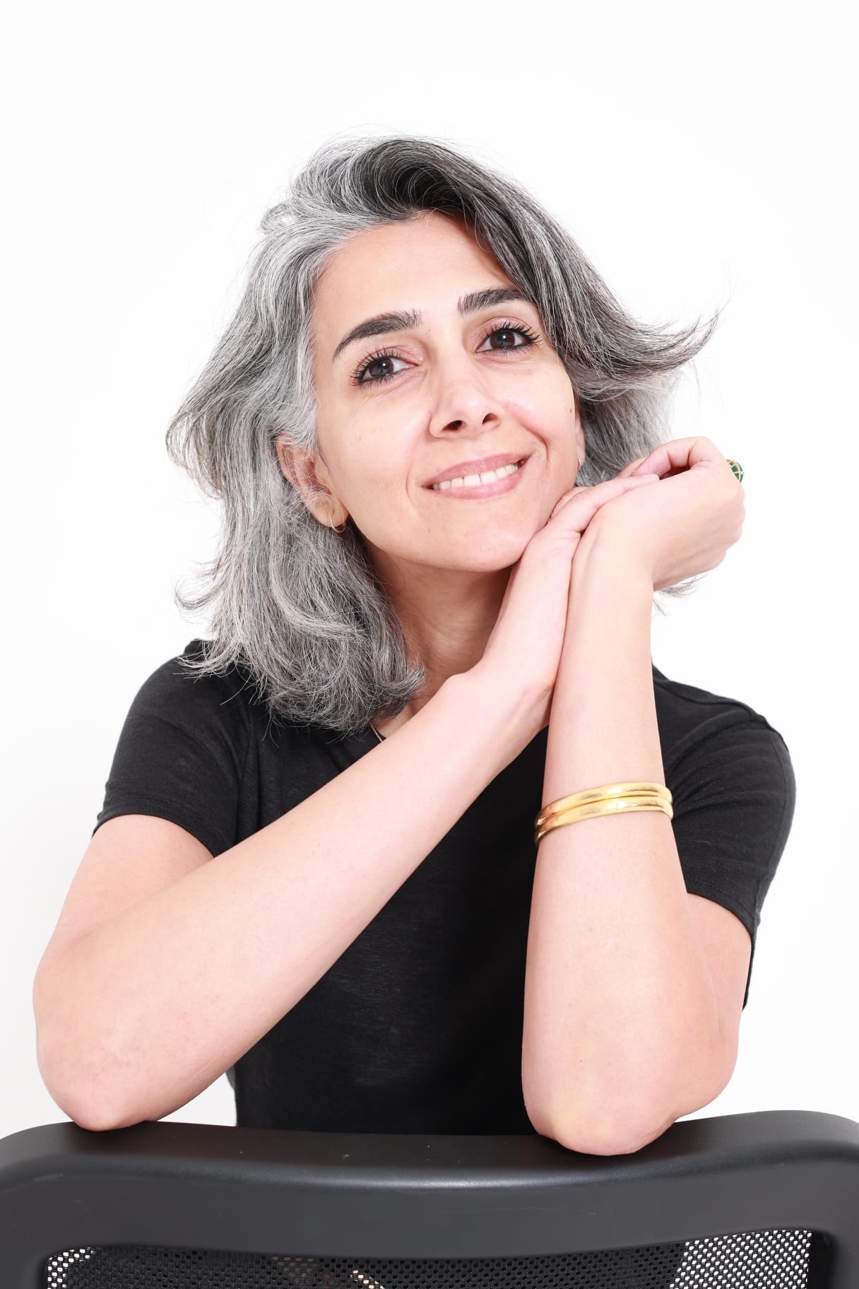 Dr Sanaa Al-Raisi, Oral Surgeon at Facial Diagnostic Clinic in London, smiling in a professional portrait